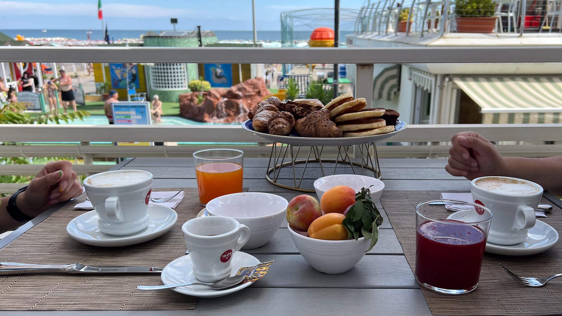 Beachside breakfast with coffee, juices, and pastries.