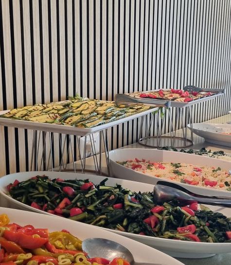 Colorful vegetable buffet on white dishes.