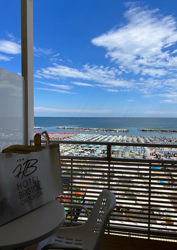 Sea view from the hotel with colorful beach umbrellas.