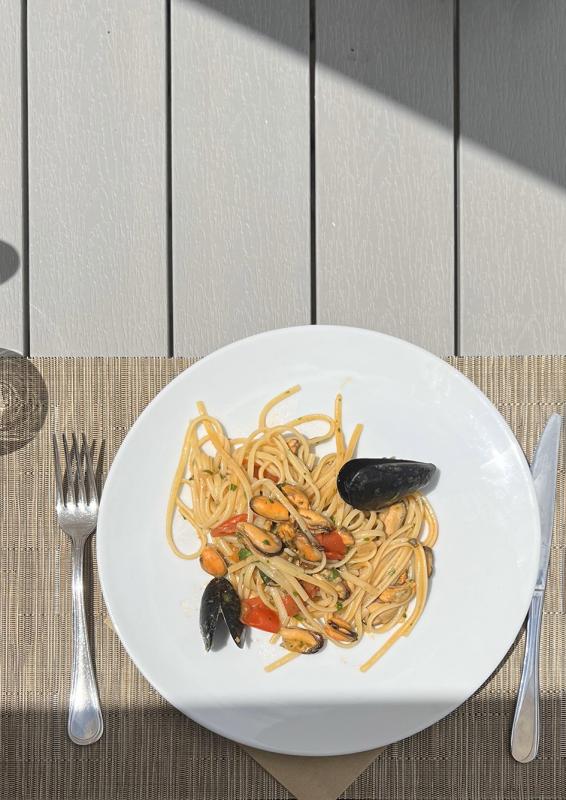 Seafood spaghetti on an outdoor table.